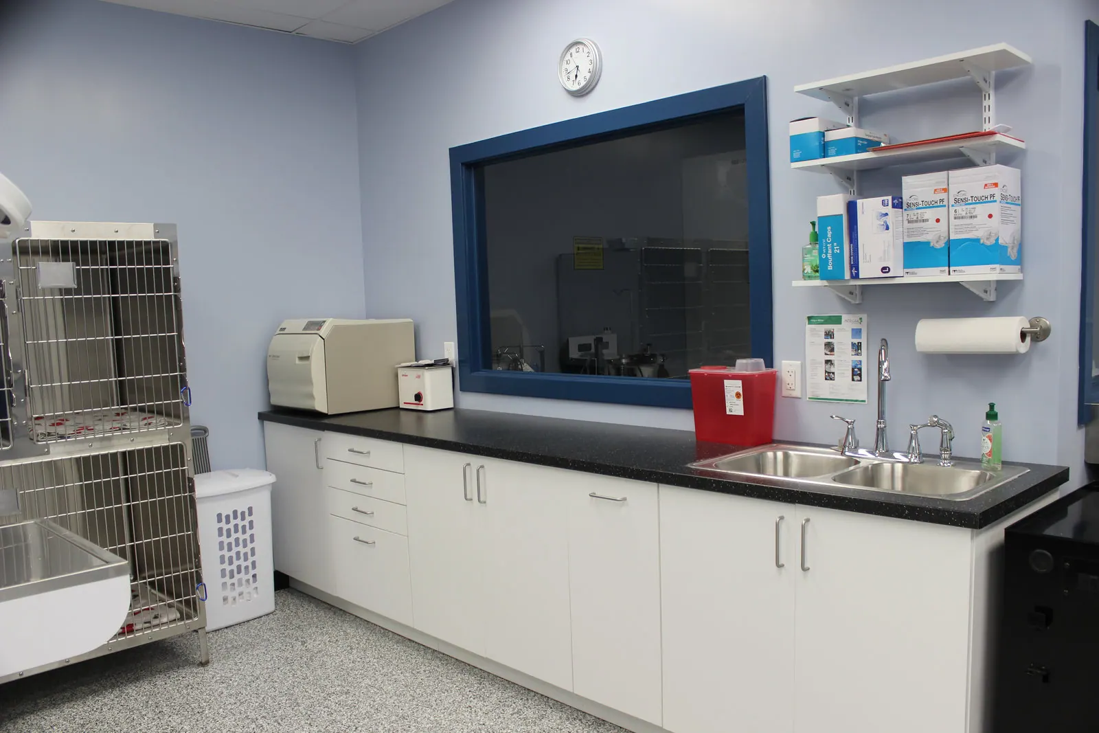 Treatment prep area with autoclave, centrifuge, and stainless steel kennels