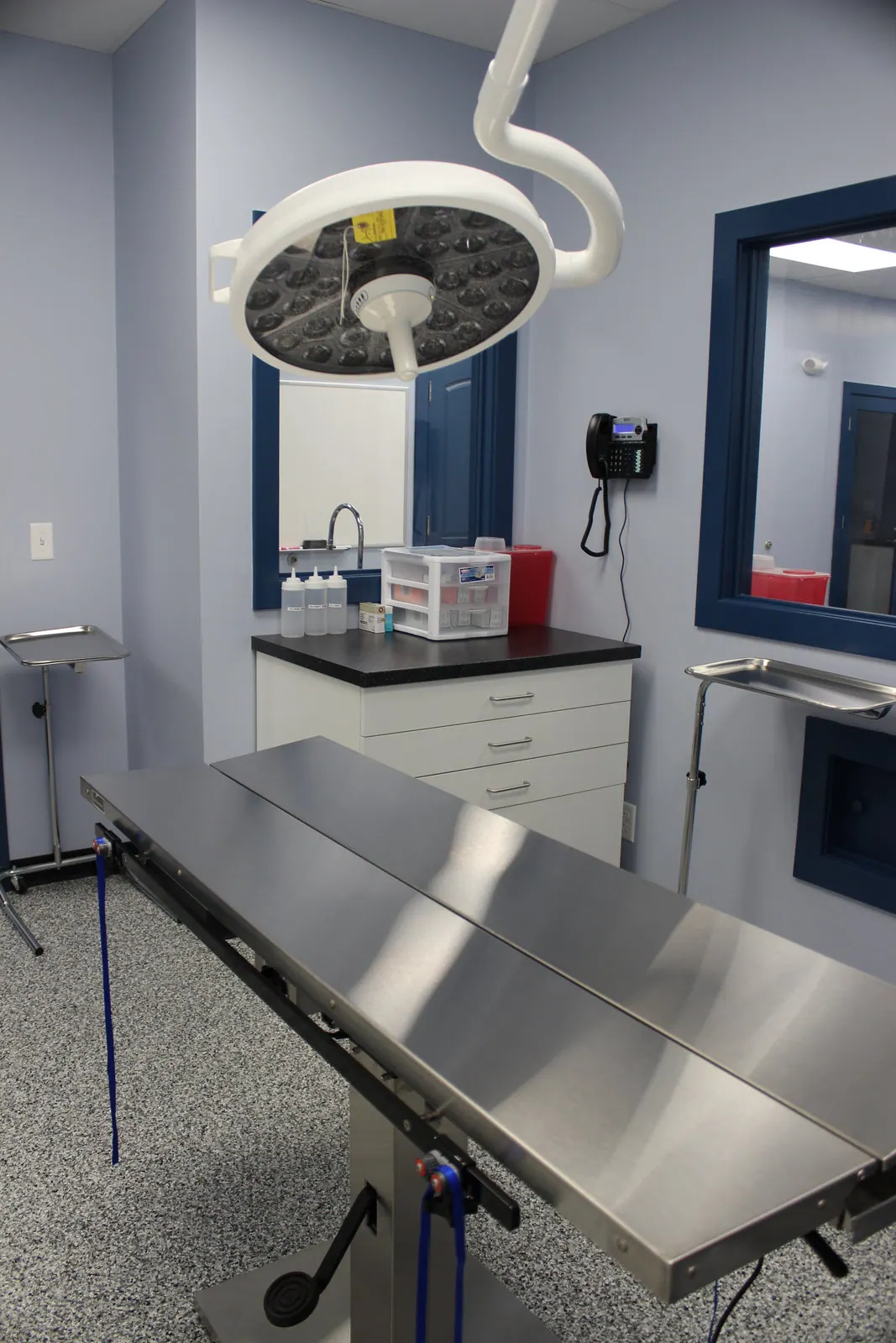 Surgical suite with stainless steel table and overhead surgical light